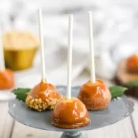 tiny caramel apples on a silver stand