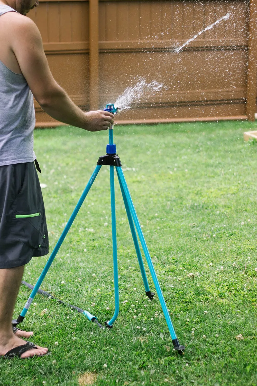 Telescoping sprinkler in yard.