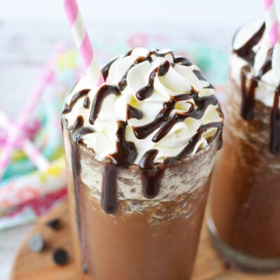 Java chip frappuccino with a pink straw and topped with whipped cream and syrup