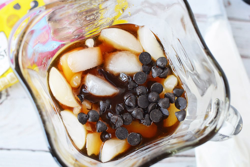 Ice, coffee, and chips in a blender. 