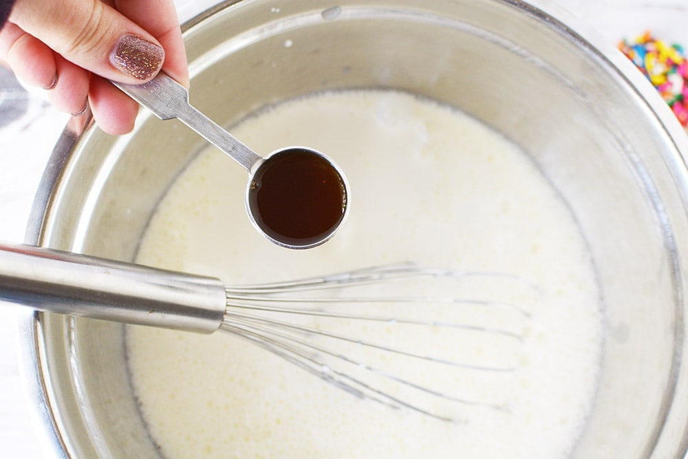 Adding vanilla to a bowl.