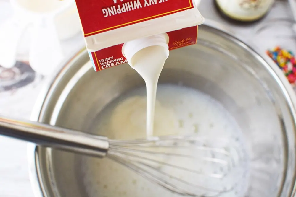 Pouring cream into bowl.