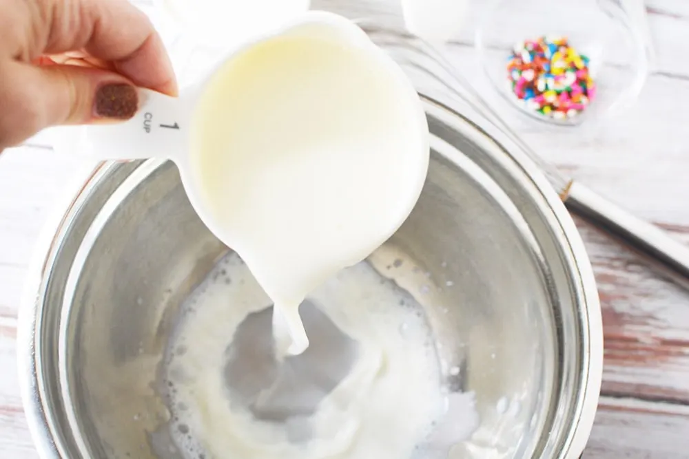 Pouring milk into a bowl.