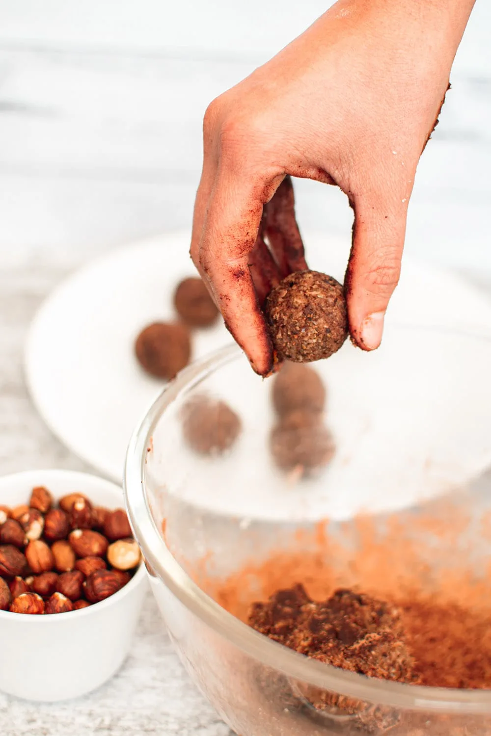 Rolling the date mixture into energy balls.
