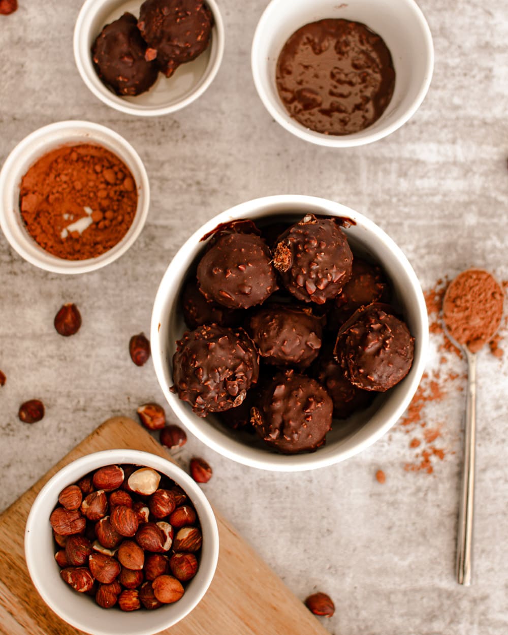 Overhead image of date balls and bowls of hazelnuts and other ingredients.