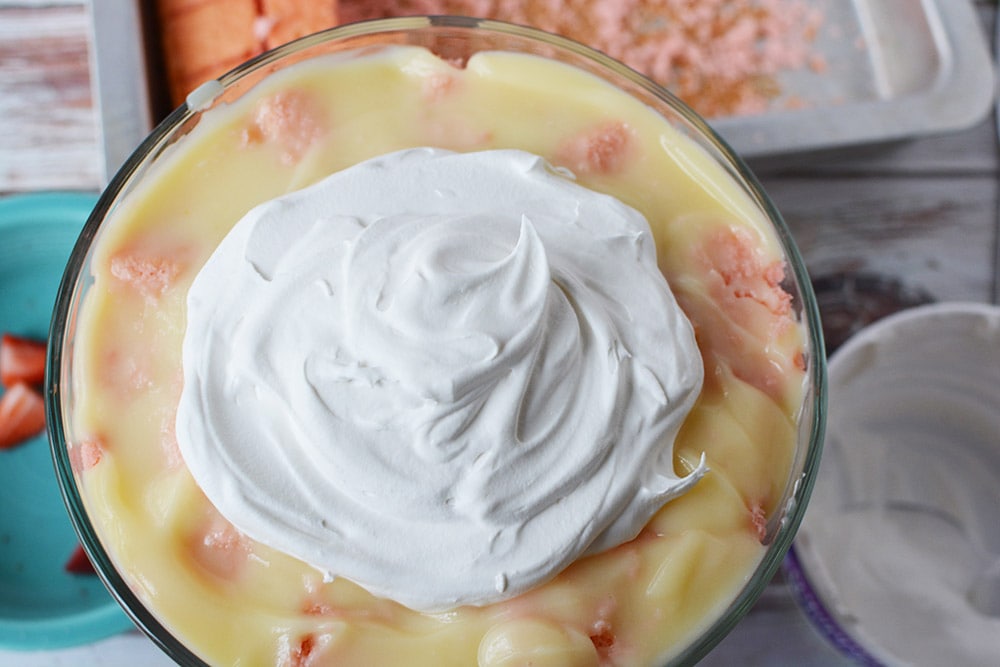 Large dollop of whipped cream on top of pudding.