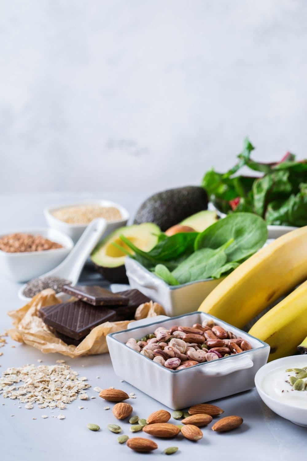 Nuts, bananas, and other foods high in magnesium on a table.