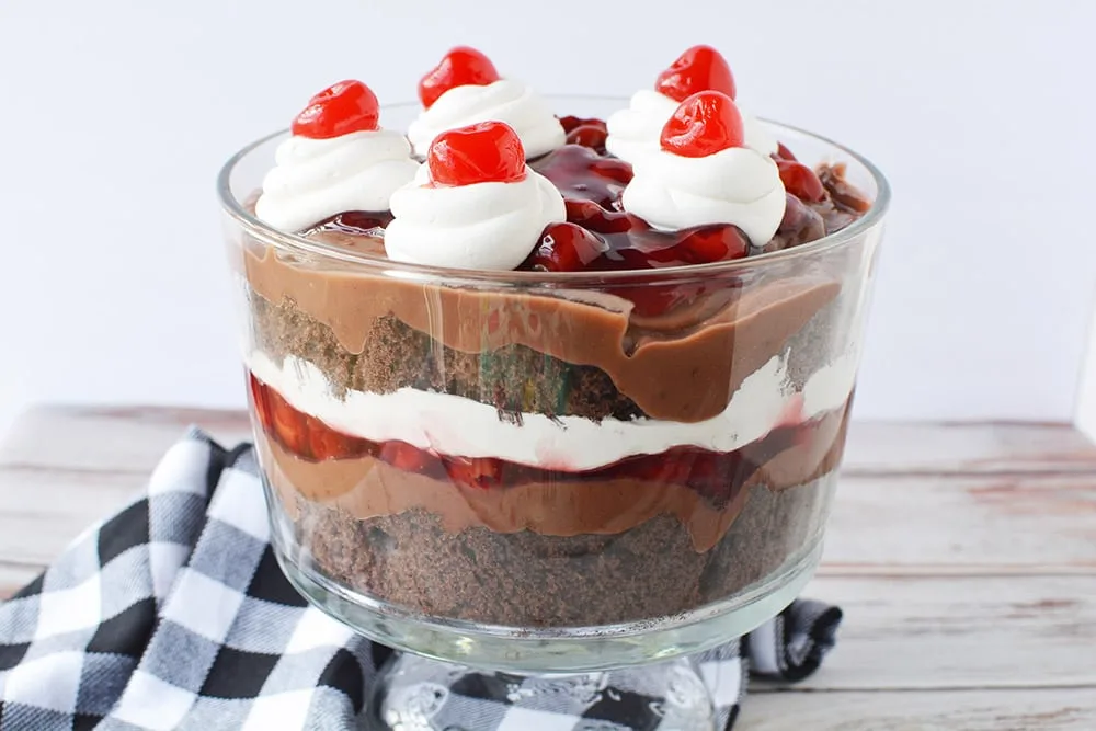 Black forest trifle in a bowl with a checkered napkin.