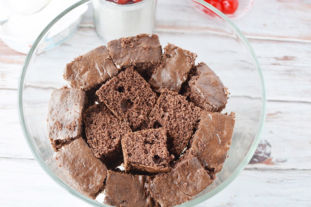 Cubes of chocolate cake in a trifle bowl. 