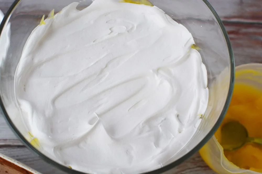 Whipped cream in a trifle bowl.