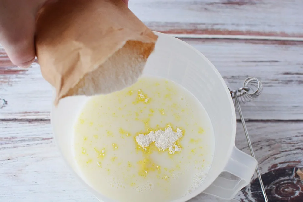 Mixing pudding mix with milk.