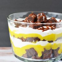 Layers of brownies, pudding, and whipped cream in a trifle dish.