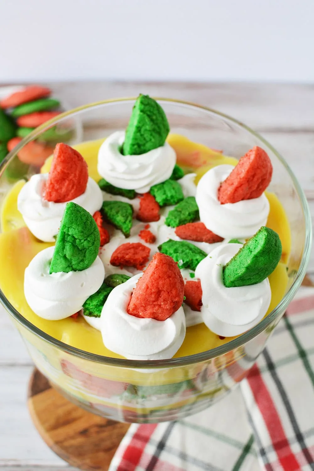 Top of Christmas trifle with red and green cookies in the whipped cream topping.