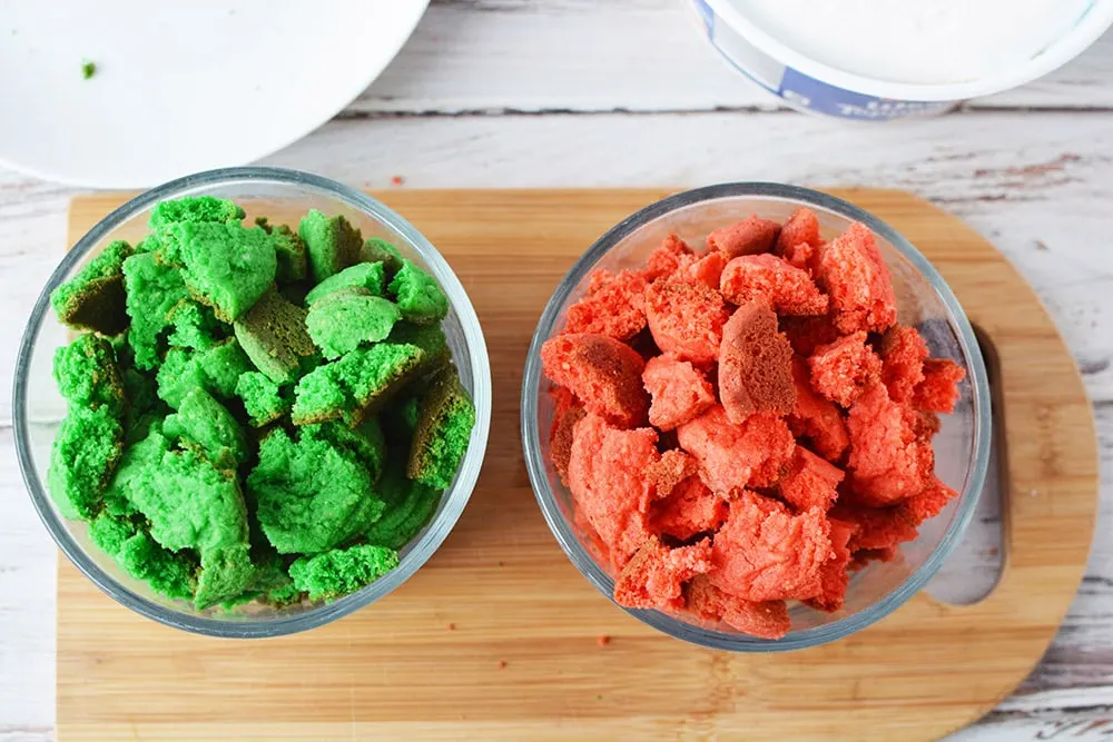 Red and green cookies broken up into bowls.