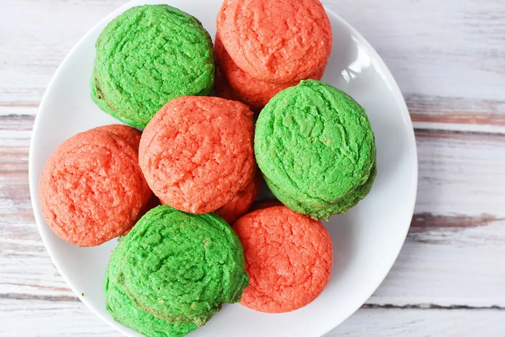 Red and green sugar cookies on a plate.