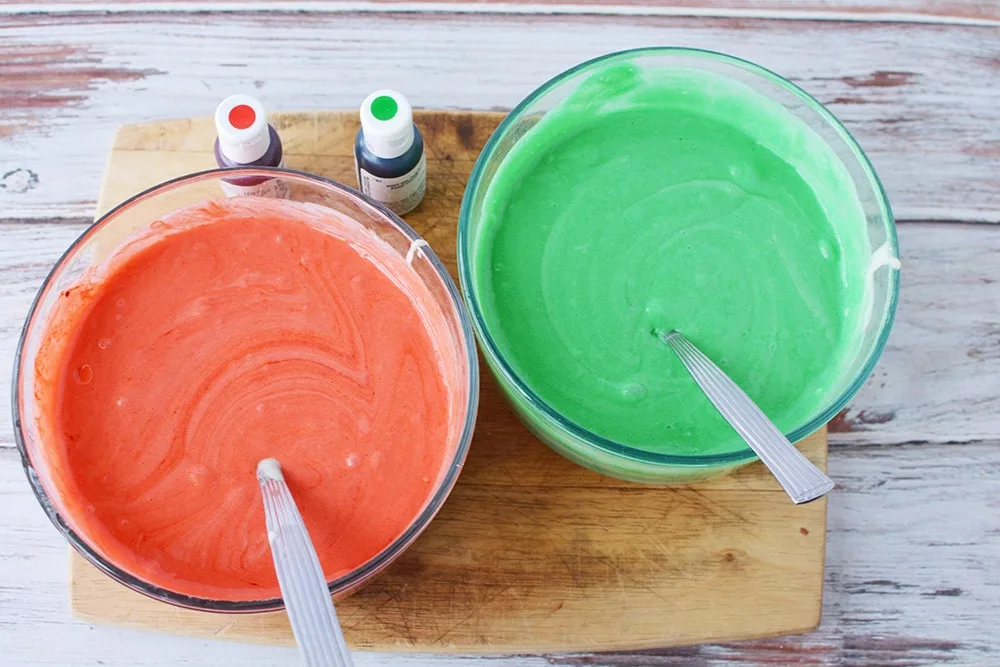 Food coloring in cake mix in bowls. 