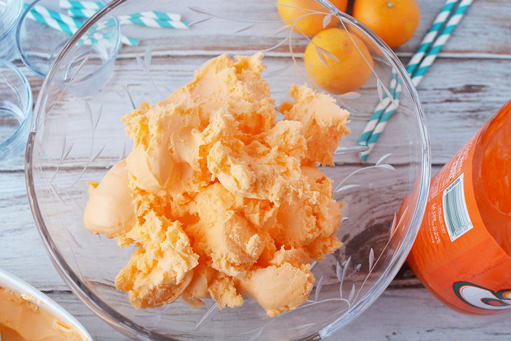 Punch bowl with orange sherbet in it. 