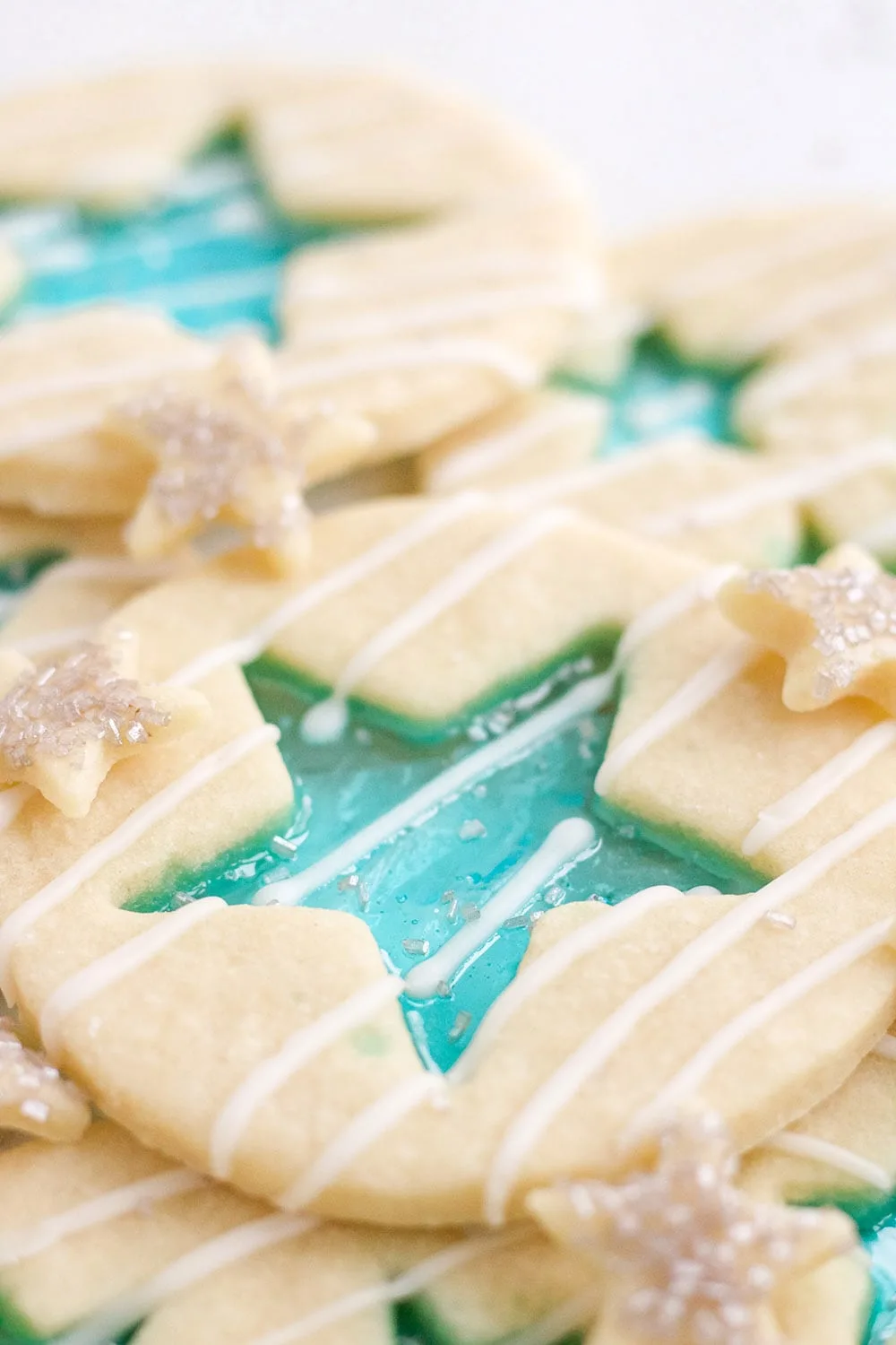 Jolly Rancher candy cookies with blue stars and white glaze.