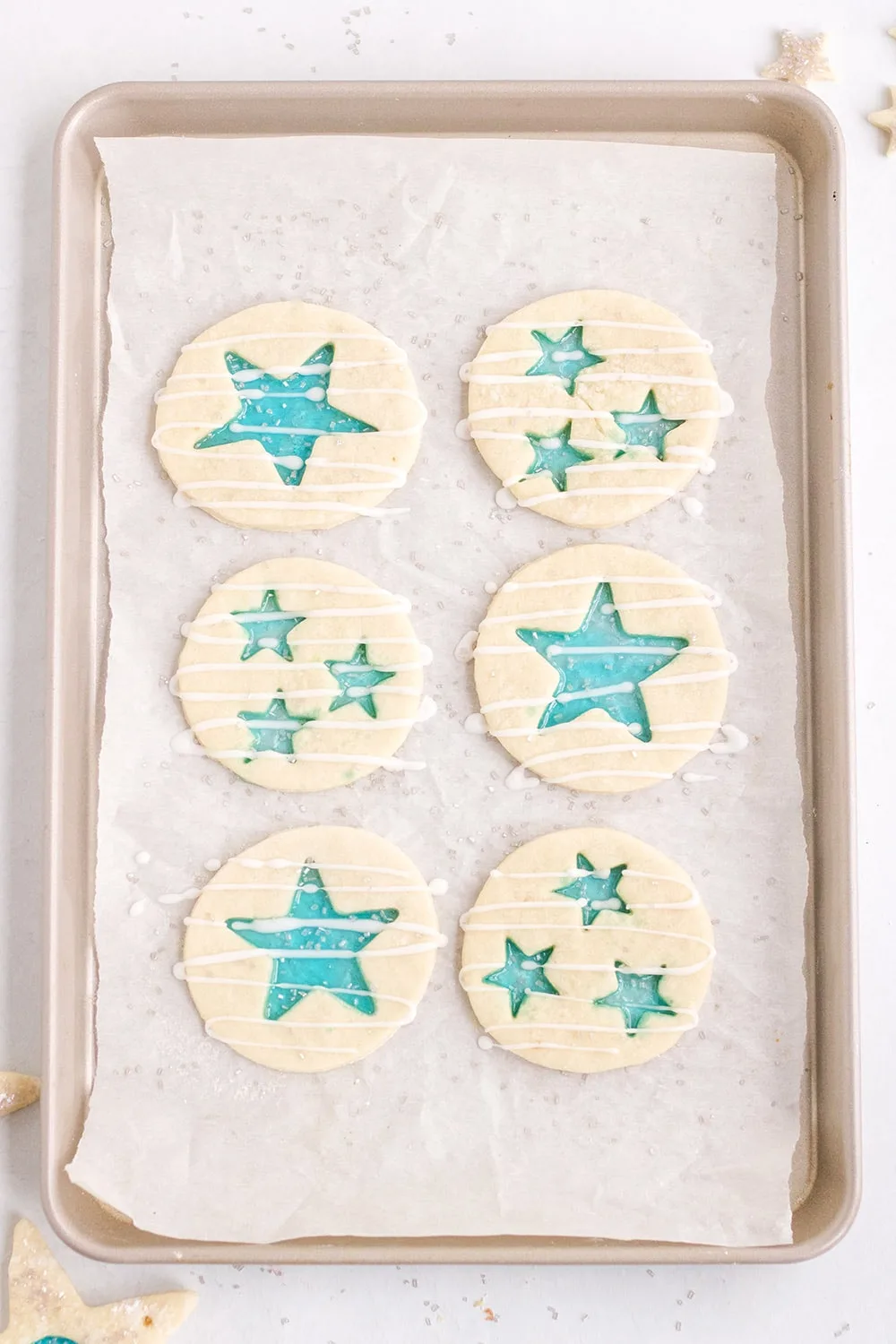 Star stained-glass cookies on a baking sheet ready for the oven. 