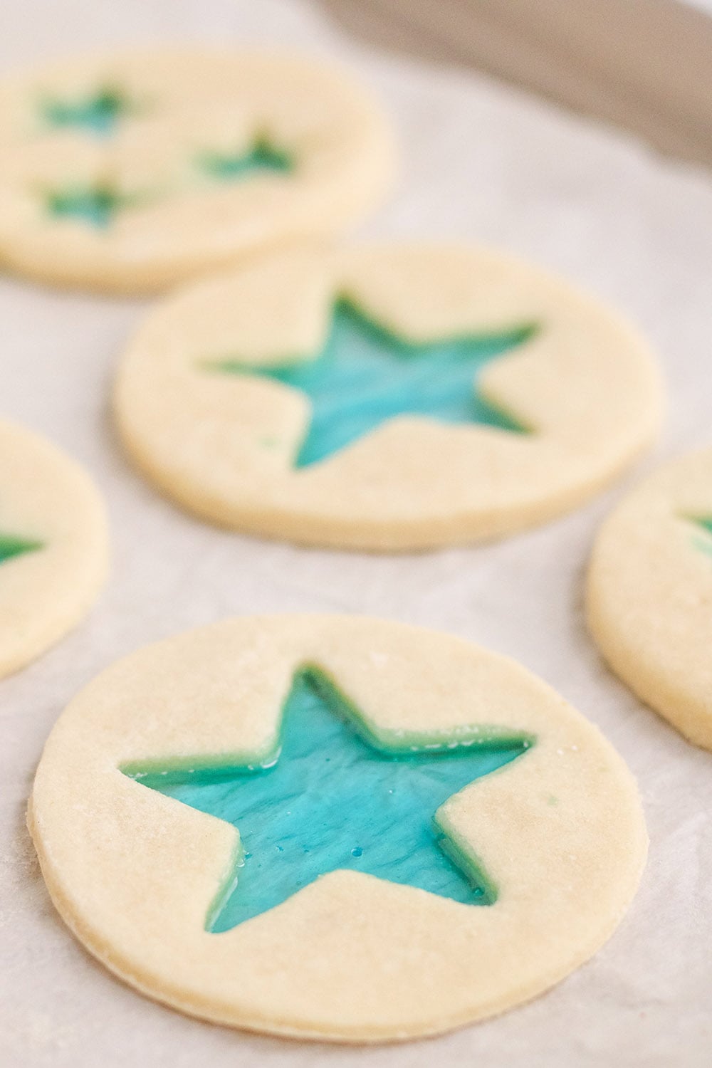 Stained-glass star cookies ready to bake on a baking sheet. 