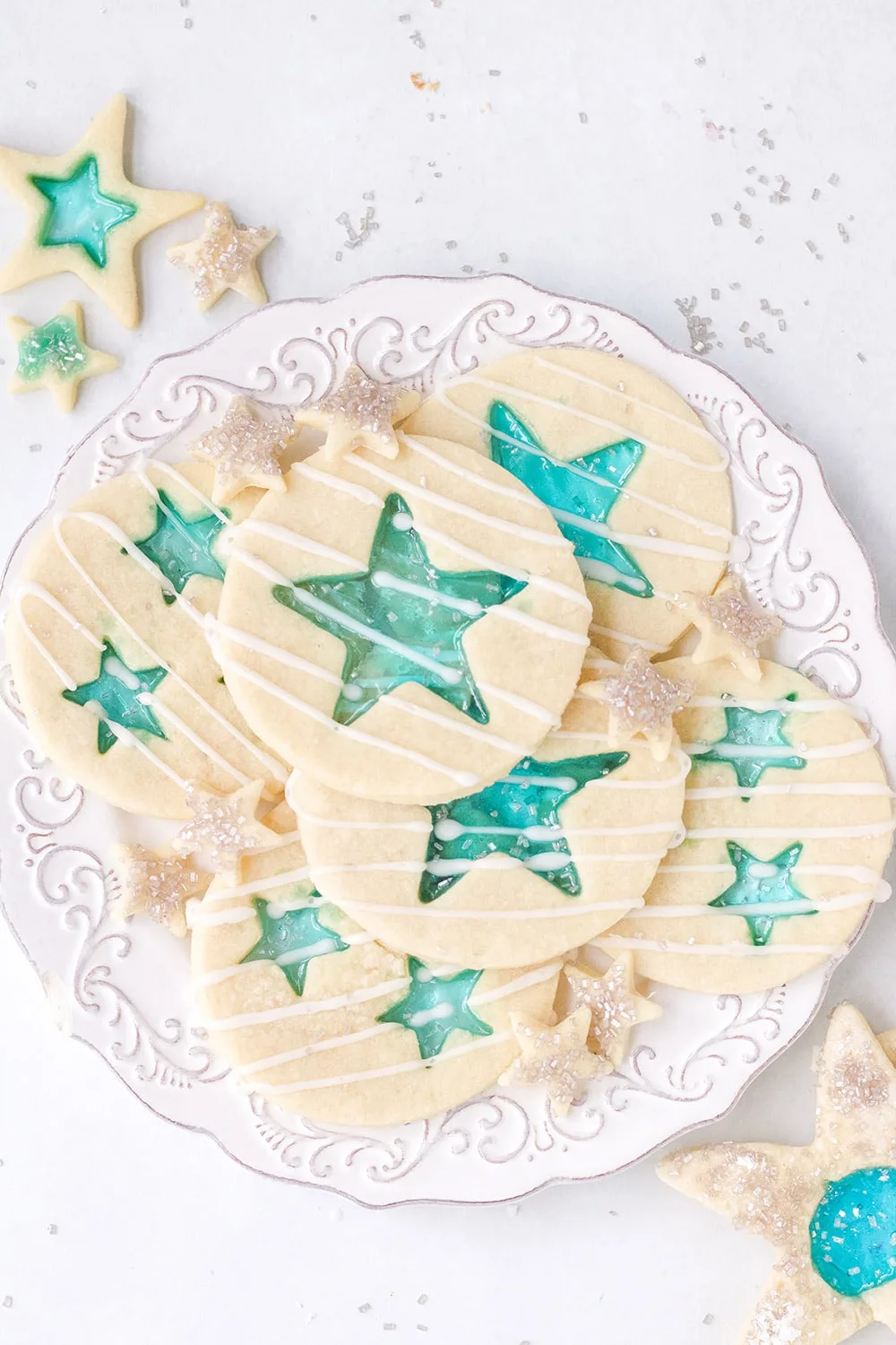 White plate of blue star cookies. 