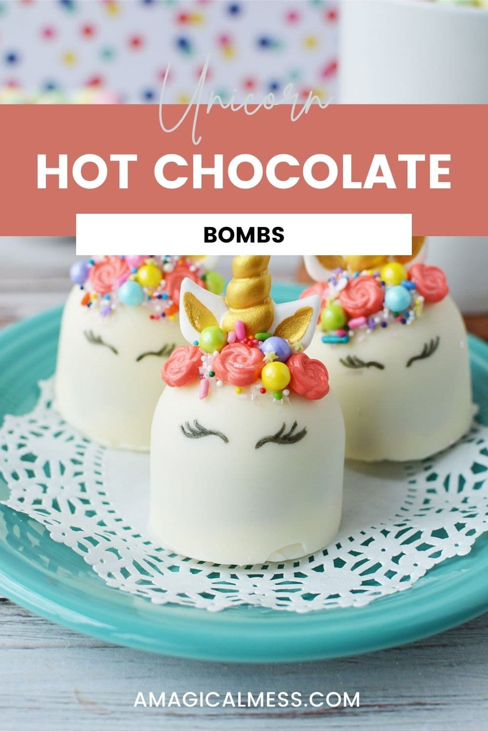 Unicorn white hot chocolate bombs with faces, gold horns, and flower manes on a blue plate.