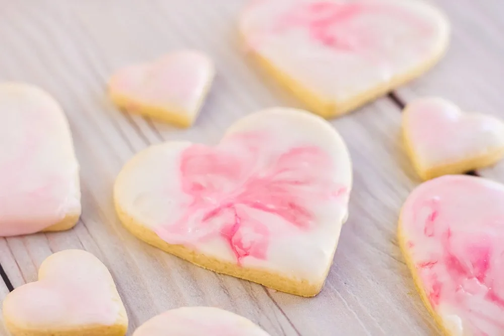 Pink icing on a heart sugar cookie.