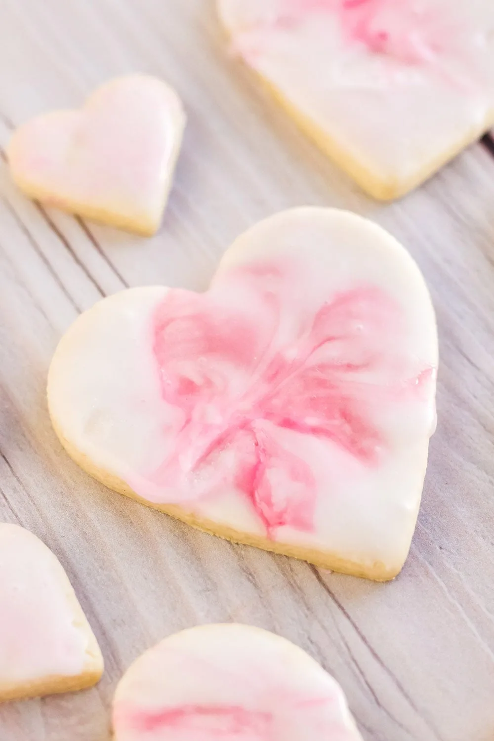 Valentine's day heart sugar cookies with pink marble icing.