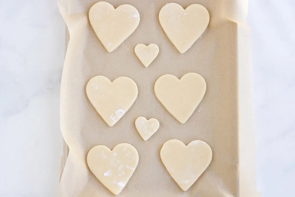 Sugar cookie hearts on baking sheet