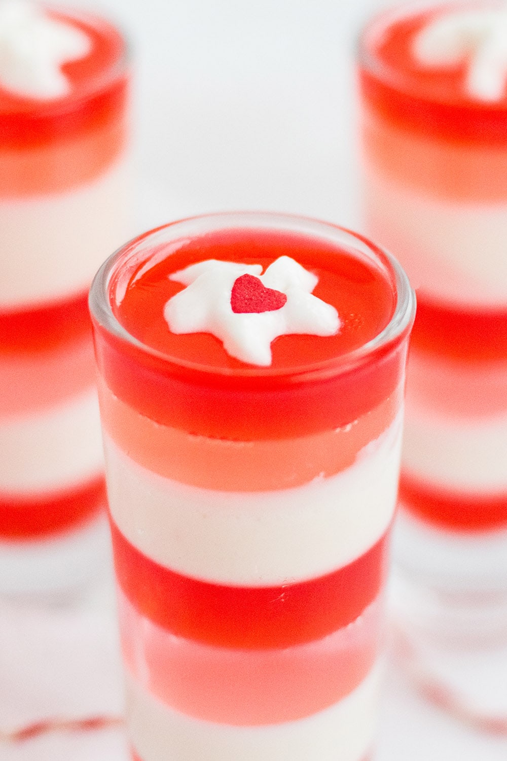 Top of layered jello with whipped cream dollop.