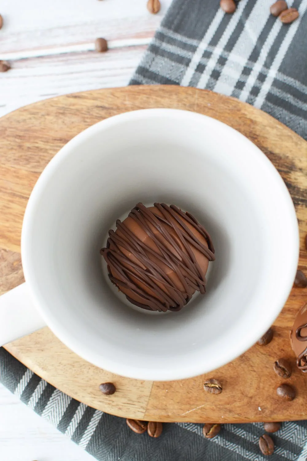 A chocolate coffee bomb in a mug.