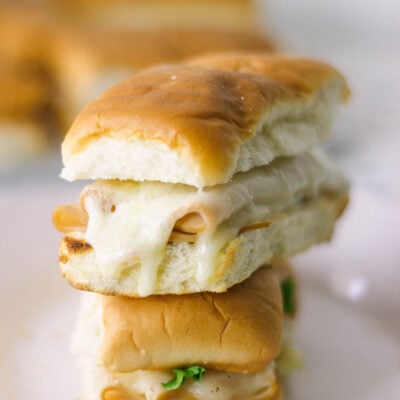 Stacked turkey melts on a plate.