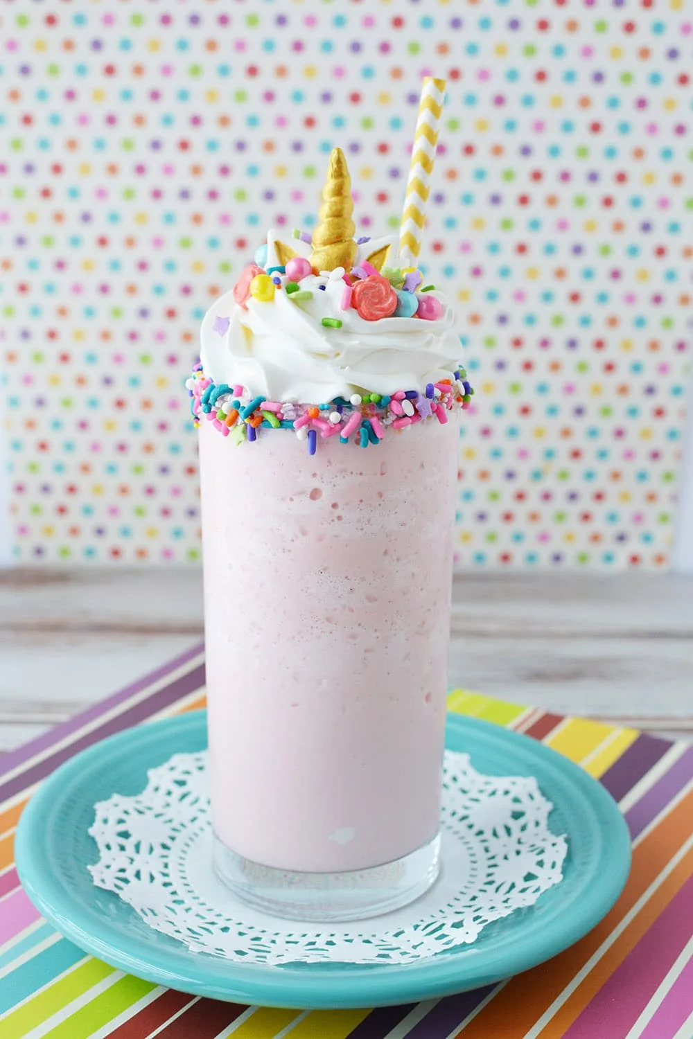 Pink blended drink with unicorn toppings.