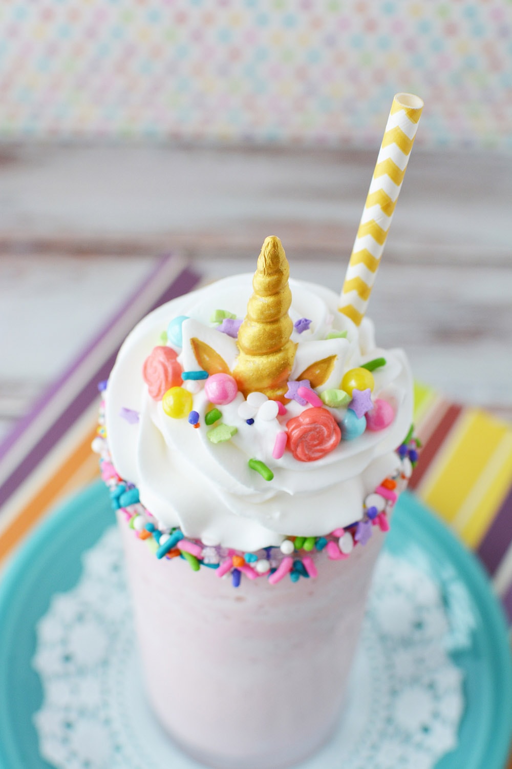 Cotton candy frappuccino with unicorn horn candy and other toppings to look like a unicorn frappuccino.