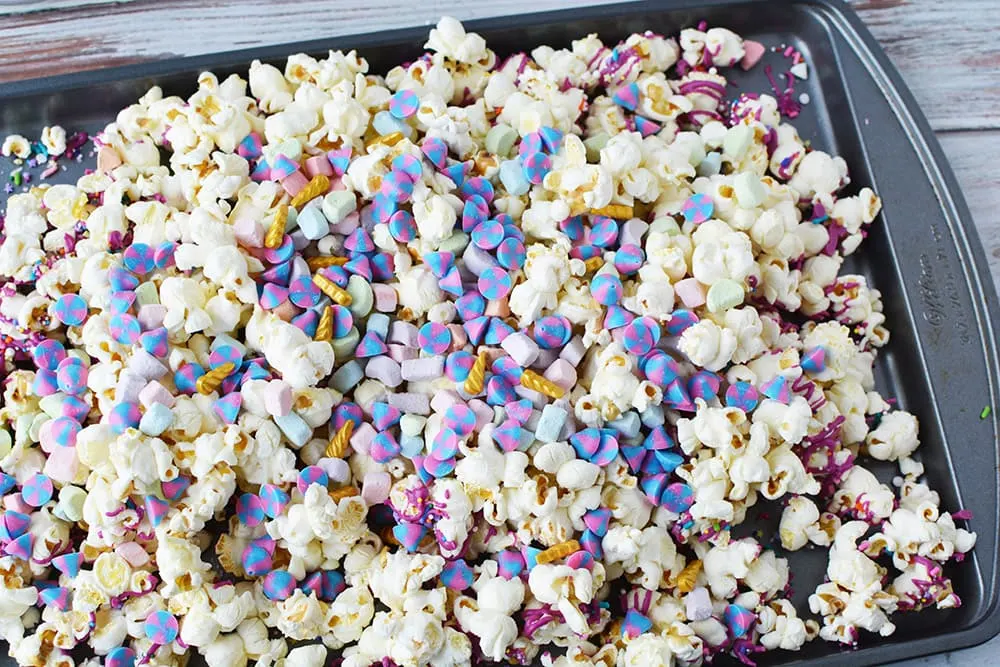 Candy and popcorn on a baking sheet.