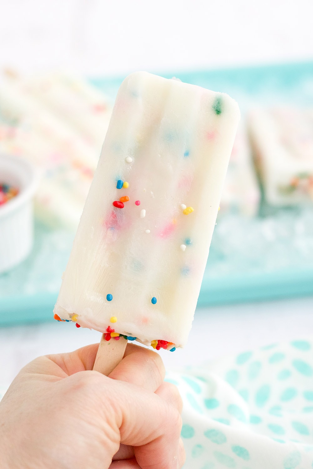 Holding a cake mix popsicle. 