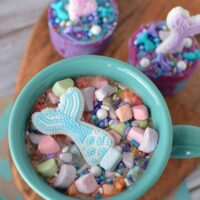 Mermaid tail floating in a mug of hot cocoa.