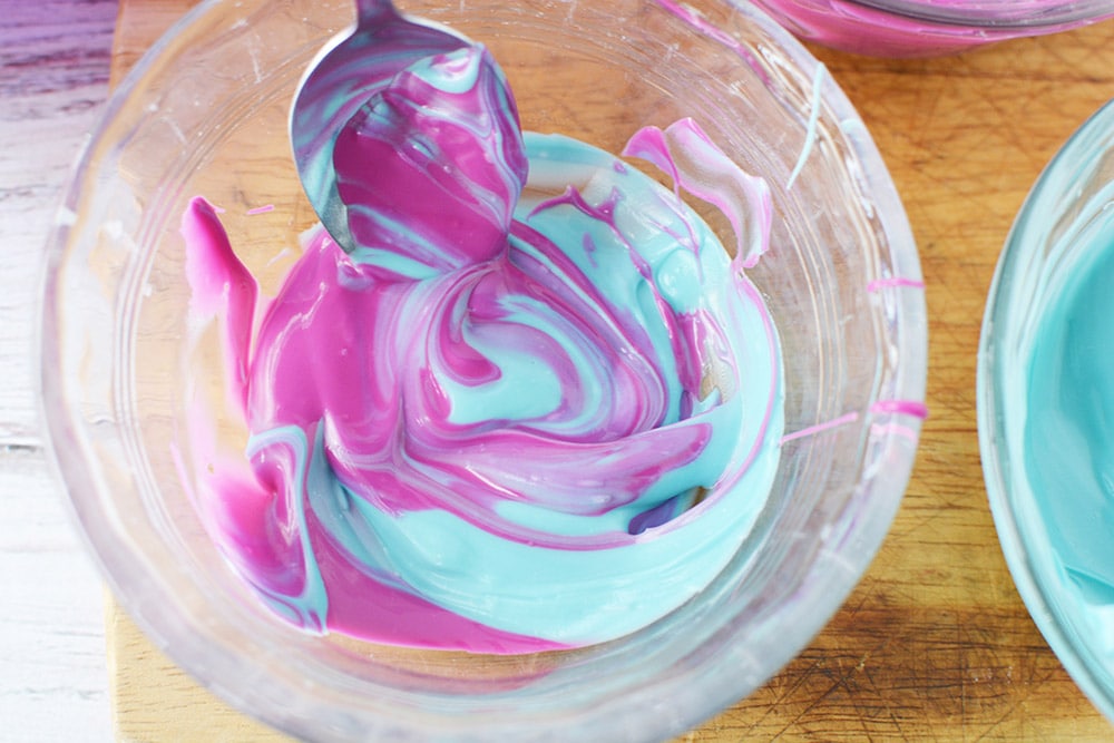Swilring blue and purple candy melts together.