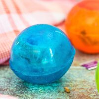 Hot tea bomb in blue and orange sitting on a counter.