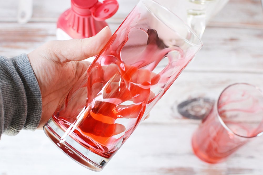 Pink syrup in a clear glass.