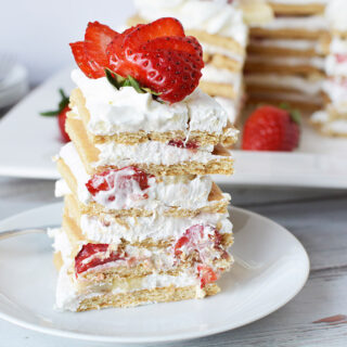 Stacked ice box cake with strawberries.