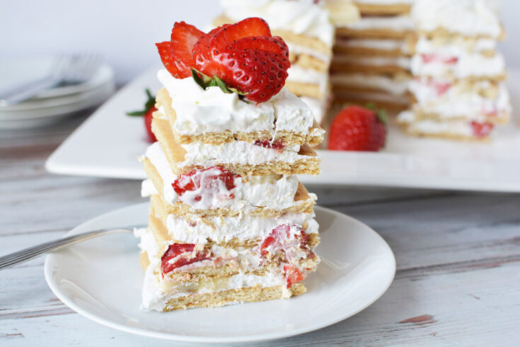 Stacked ice box cake with strawberries.