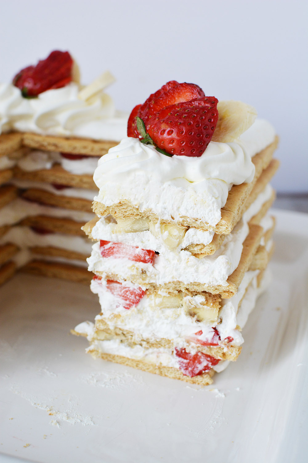 Sliced and layered ice box cake with strawberries.