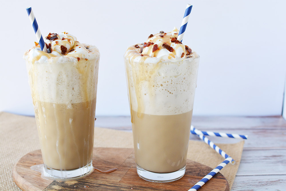 Two glasses of a caramel crunch coffee drink.