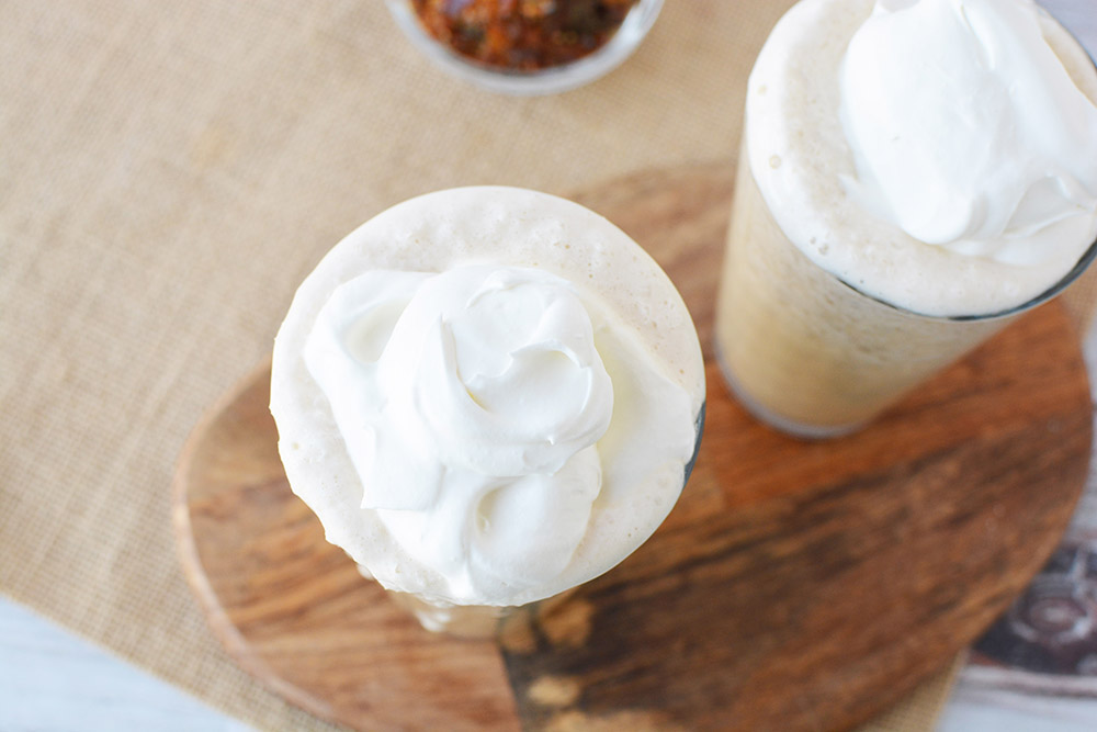 Whipped cream on top of caramel crunch drinks.