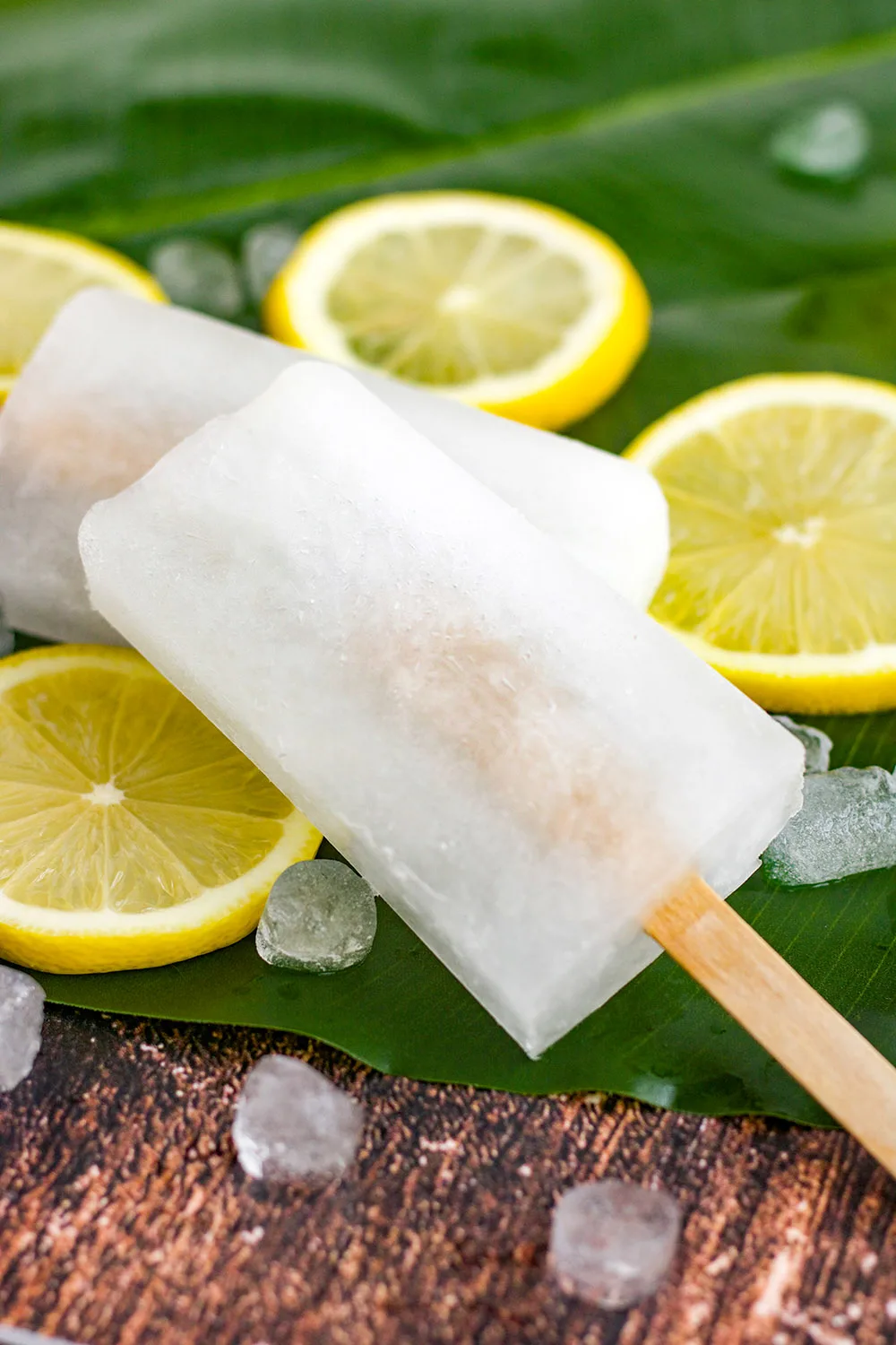 Two stacke popsicles on top of lemon slices.