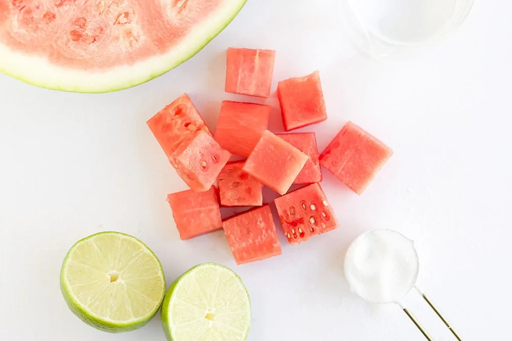 Chunks of watermelon next to other ingredients. 