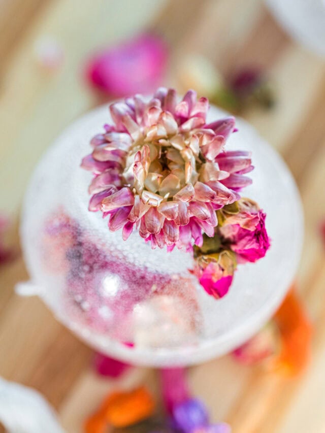 Tea drop with a flower on it on a board.