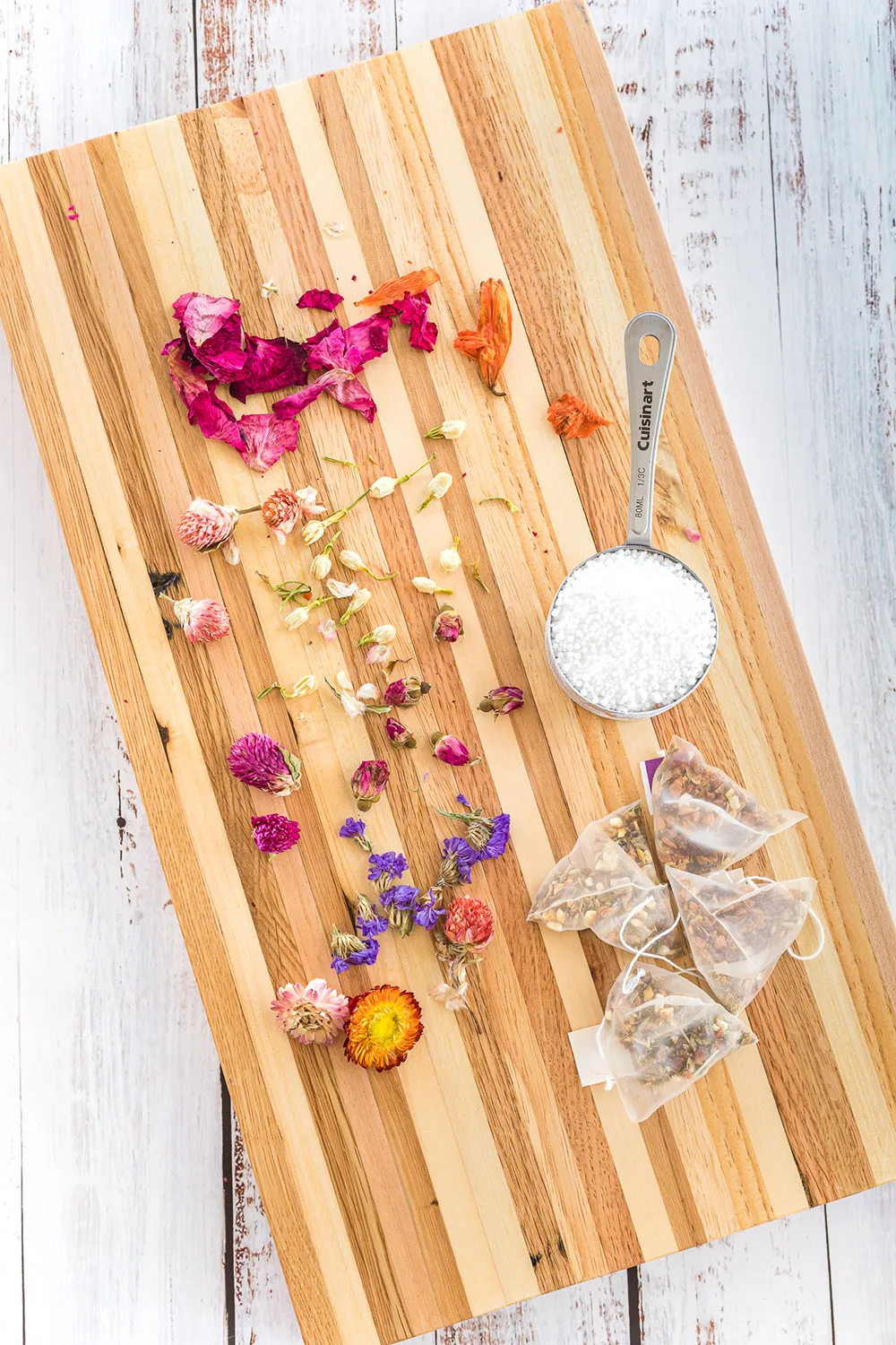 Board full of ingredients to make floral tea globes.
