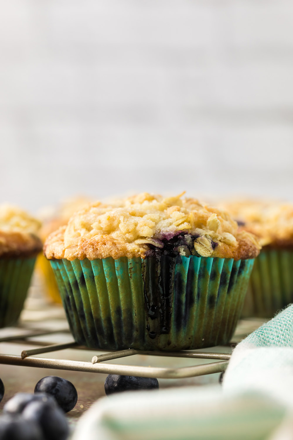 Blueberry muffin in a blue muffin liner.